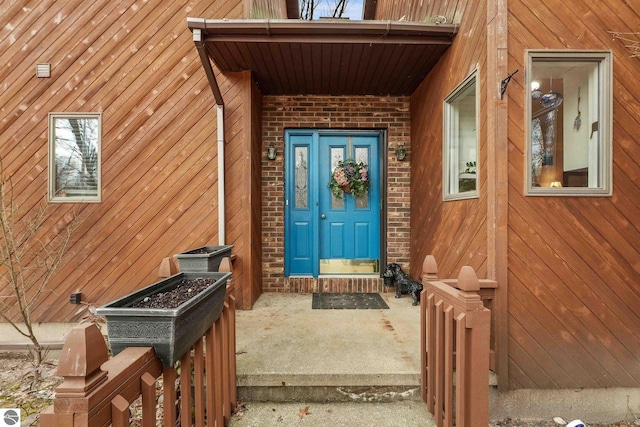 doorway to property with brick siding