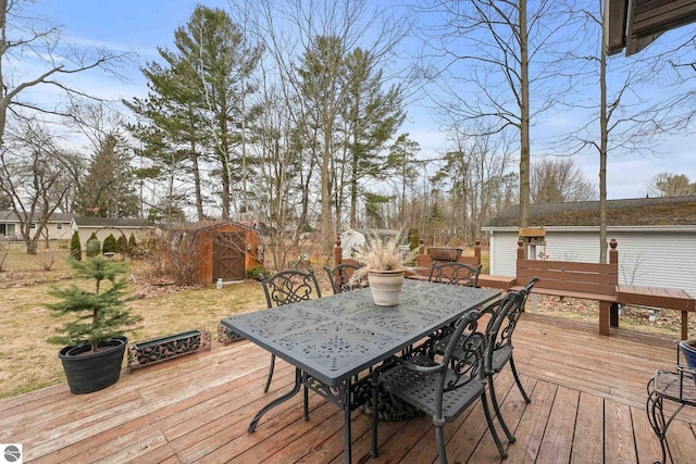 deck featuring an outdoor structure and outdoor dining space
