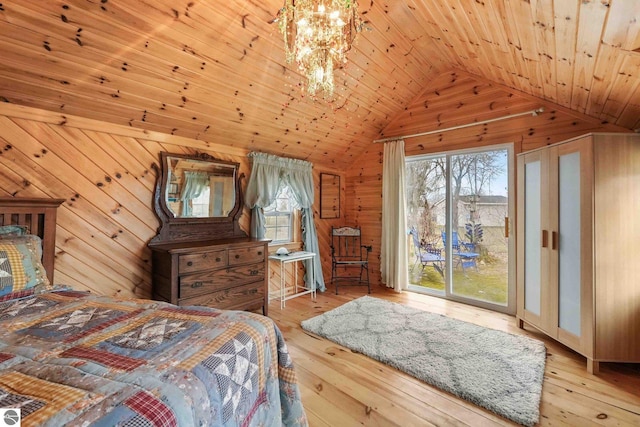 bedroom featuring vaulted ceiling, wooden walls, access to outside, and wood-type flooring