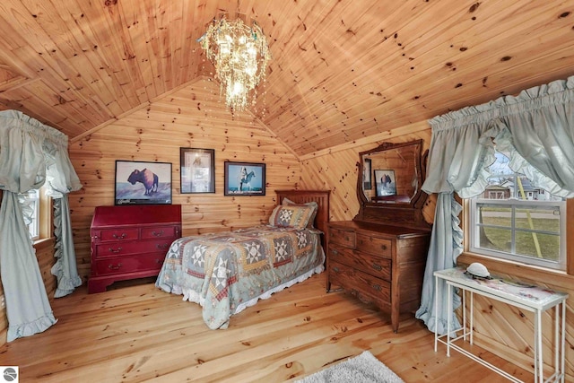 bedroom featuring an inviting chandelier, lofted ceiling, wood ceiling, wooden walls, and wood-type flooring