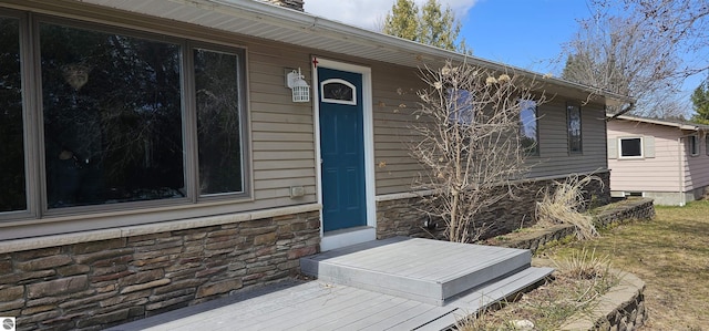 view of exterior entry featuring stone siding