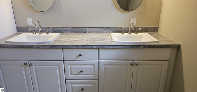bathroom with a sink and double vanity