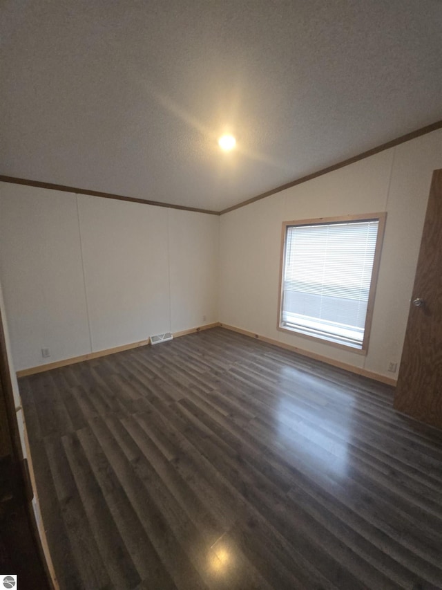 1215 S W County Line Rd, Sumner, MI 48889 - unfurnished room featuring baseboards, crown molding, dark wood-type flooring, and visible vents