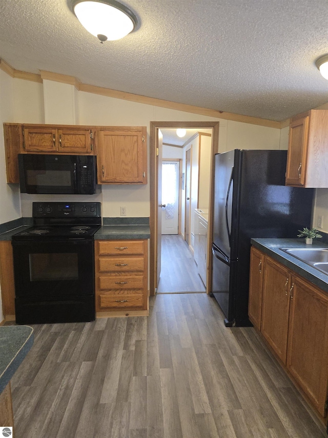 1215 S W County Line Rd, Sumner, MI 48889 - kitchen with dark countertops, a textured ceiling, and black appliances