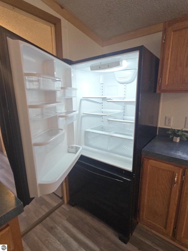 1215 S W County Line Rd, Sumner, MI 48889 - details featuring dark wood finished floors, brown cabinets, dark countertops, and a textured ceiling