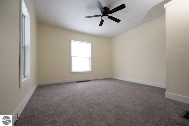 spare room with ceiling fan, baseboards, carpet flooring, and visible vents