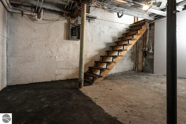 unfinished below grade area with stairs and electric panel