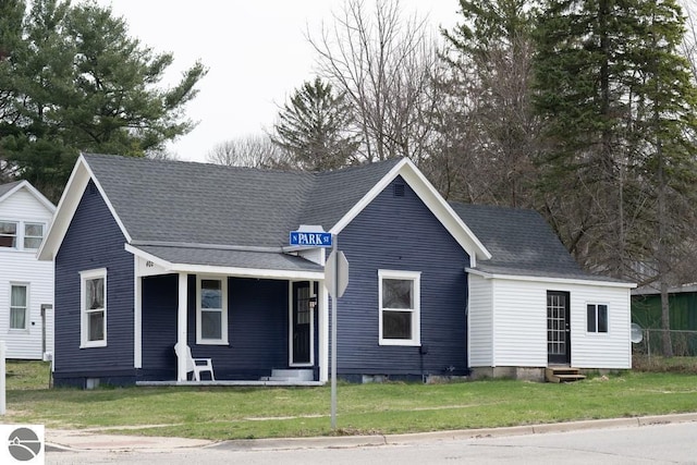 view of front of house featuring entry steps, a front yard, and covered porch