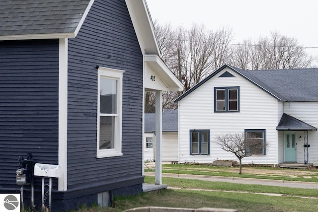 view of home's exterior with a shingled roof