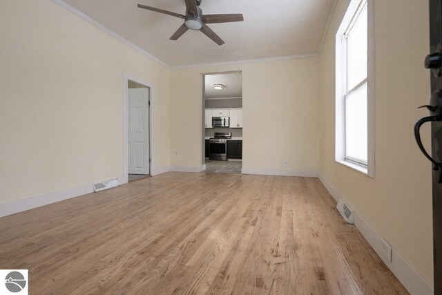 unfurnished living room with ceiling fan, crown molding, visible vents, and light wood-style flooring