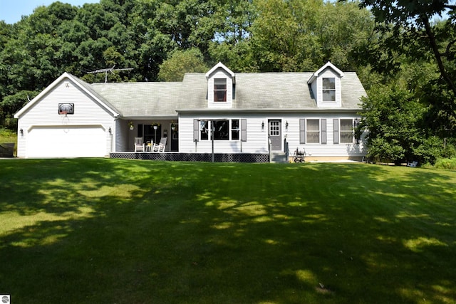 1069 El Camino Grande Dr, Lake Isabella, MI 48893 - cape cod-style house featuring a front yard and a garage