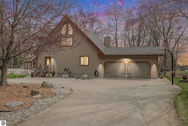 2000 Granada Ct, Weidman, MI 48893 - chalet / cabin featuring driveway, roof with shingles, a chimney, and an attached garage