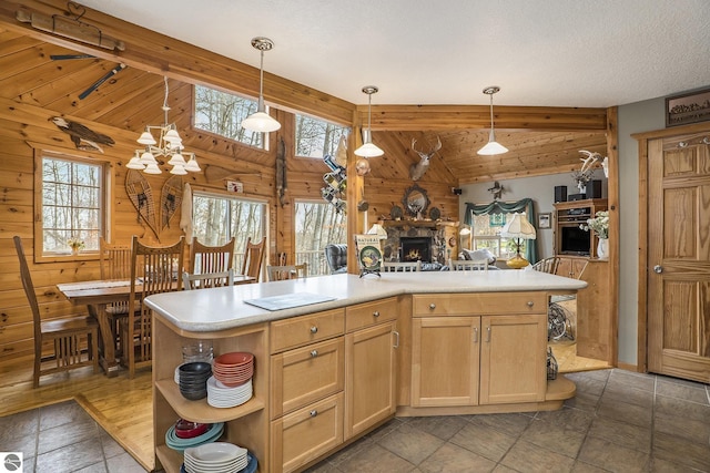 2000 Granada Ct, Weidman, MI 48893 - kitchen featuring wood walls, vaulted ceiling with beams, a wealth of natural light, and a stone fireplace