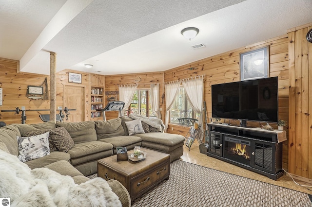 2000 Granada Ct, Weidman, MI 48893 - living area with visible vents, wood walls, and a textured ceiling
