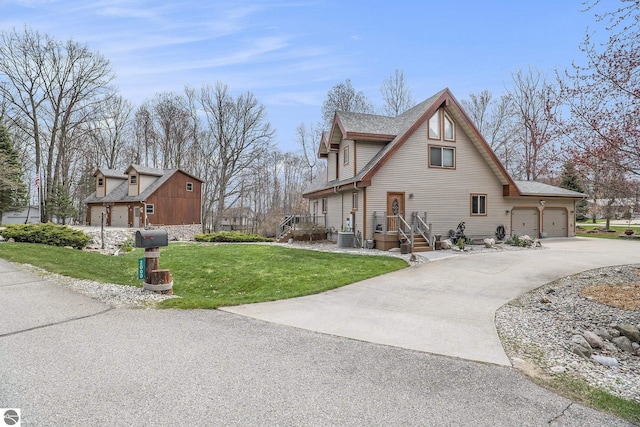2000 Granada Ct, Weidman, MI 48893 - view of home's exterior featuring a lawn, driveway, and central air condition unit