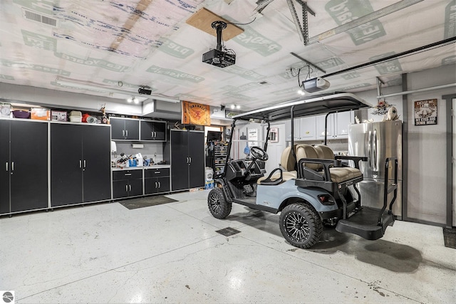 2000 Granada Ct, Weidman, MI 48893 - garage with a garage door opener