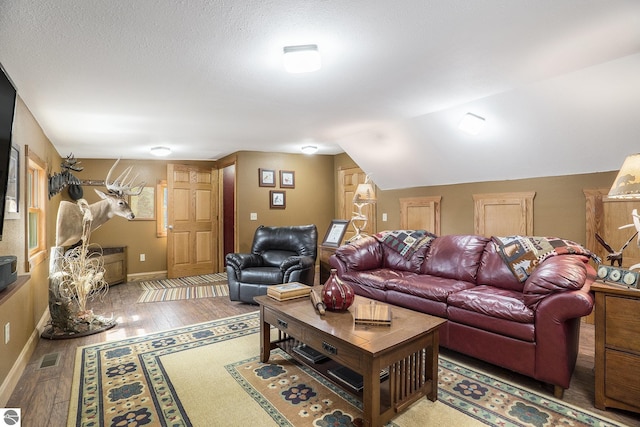 2000 Granada Ct, Weidman, MI 48893 - living room featuring baseboards and wood-type flooring