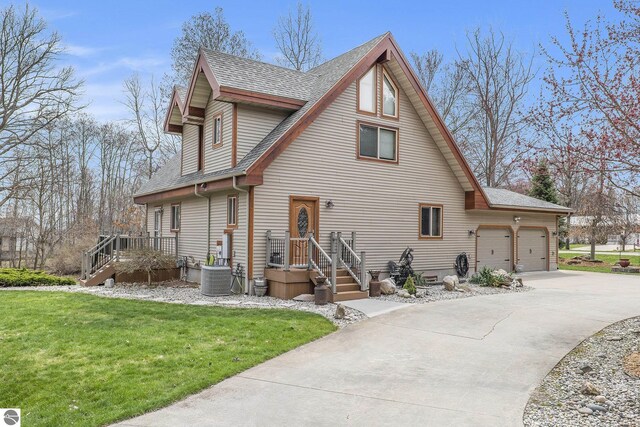 2000 Granada Ct, Weidman, MI 48893 - view of front of house with a front yard, driveway, central AC, roof with shingles, and an attached garage