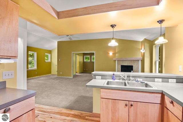 4201 N High Bluffs Dr, Leland, MI 49654 - kitchen with a tiled fireplace, pendant lighting, open floor plan, and a sink