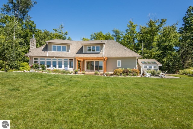 4201 N High Bluffs Dr, Leland, MI 49654 - back of house with a chimney, a patio, an outbuilding, and a yard