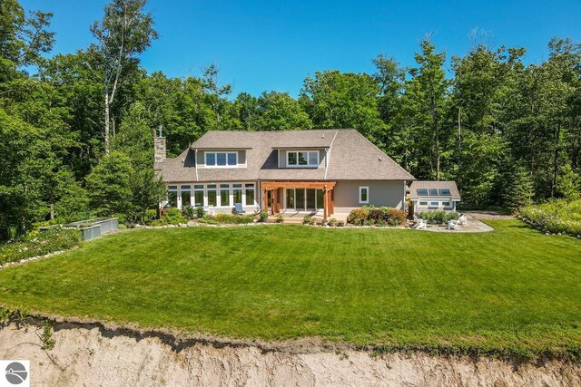 4201 N High Bluffs Dr, Leland, MI 49654 - view of front of house with a front yard and a chimney