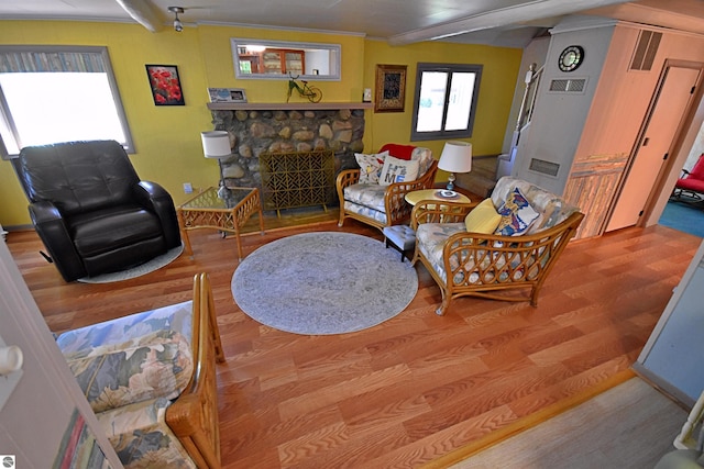 1900 Pavilion Dr, Lake City, MI 49651 - living area with visible vents, wood finished floors, and a fireplace
