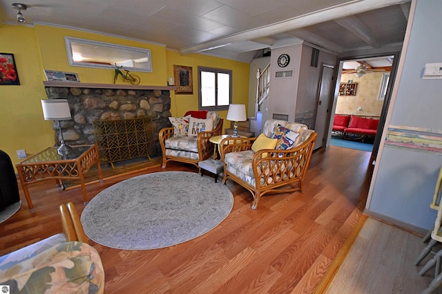 1900 Pavilion Dr, Lake City, MI 49651 - living room featuring a fireplace, wood finished floors, ceiling fan, and beamed ceiling