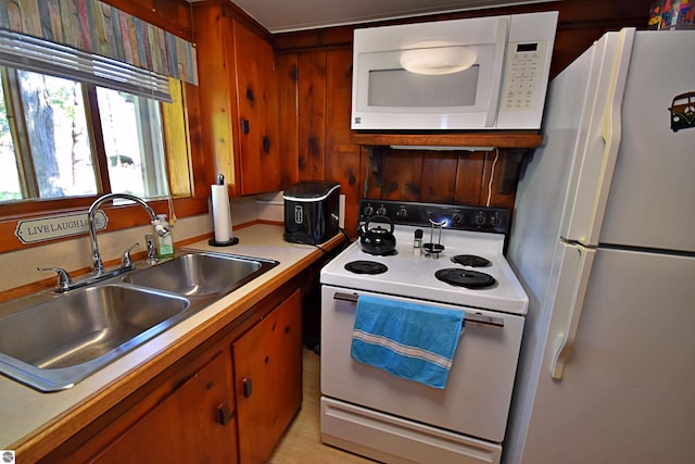 1900 Pavilion Dr, Lake City, MI 49651 - kitchen with light countertops, a sink, brown cabinetry, and white appliances