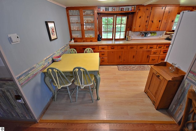 1900 Pavilion Dr, Lake City, MI 49651 - kitchen with a healthy amount of sunlight, brown cabinets, and light wood-style floors