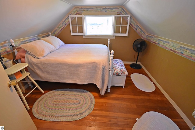 1900 Pavilion Dr, Lake City, MI 49651 - bedroom featuring baseboards, wood-type flooring, and vaulted ceiling