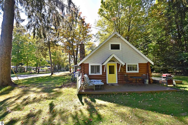 1900 Pavilion Dr, Lake City, MI 49651 - view of front facade featuring log exterior, a front yard, and a chimney