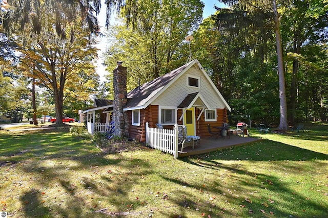 1900 Pavilion Dr, Lake City, MI 49651 - view of home's exterior featuring a chimney, a yard, and log exterior