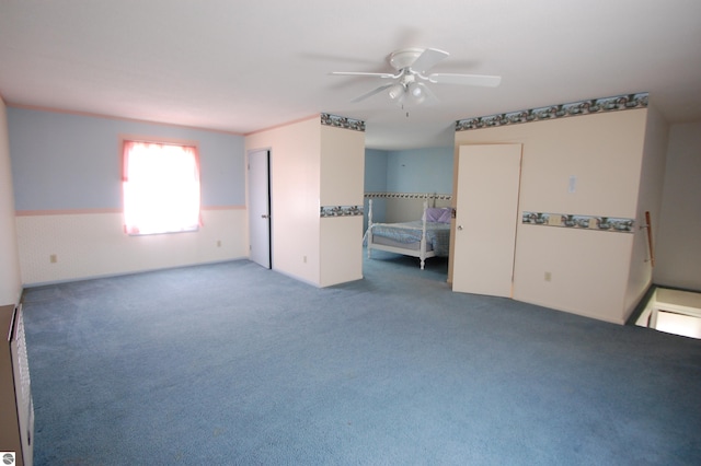 5525 S Mccauley Rd, Alger, MI 48610 - unfurnished bedroom with a ceiling fan and carpet floors
