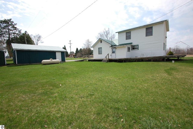 5525 S Mccauley Rd, Alger, MI 48610 - rear view of house featuring an outbuilding and a yard
