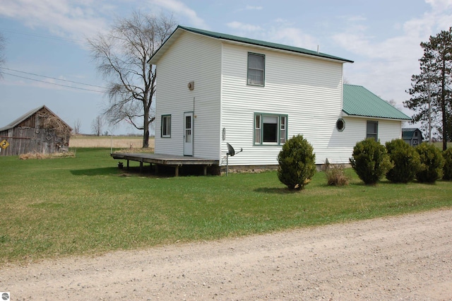 5525 S Mccauley Rd, Alger, MI 48610 - back of house featuring a yard