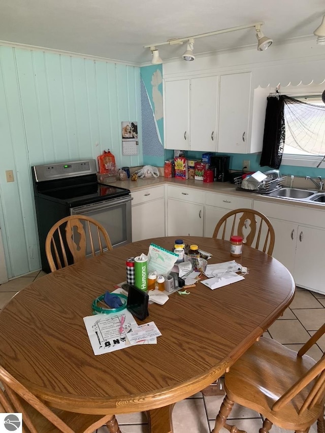 10978 Platte St, Honor, MI 49640 - kitchen with white cabinetry, a sink, light countertops, electric range, and light tile patterned flooring