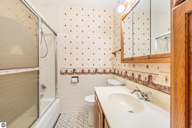 7888 E Broomfield Rd, Mount Pleasant, MI 48858 - bathroom featuring tile walls, wallpapered walls, toilet, and tile patterned flooring