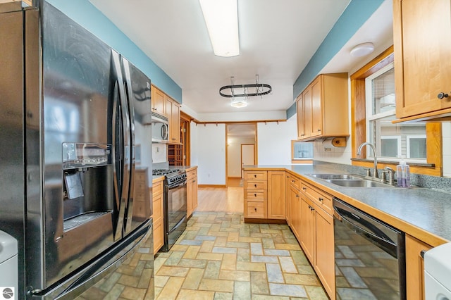 7888 E Broomfield Rd, Mount Pleasant, MI 48858 - kitchen with black appliances, brick floor, a peninsula, and a sink