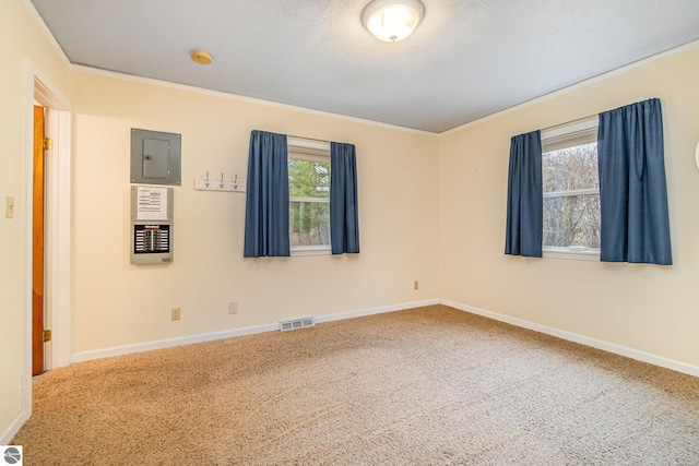 7888 E Broomfield Rd, Mount Pleasant, MI 48858 - carpeted empty room featuring visible vents, crown molding, electric panel, and baseboards