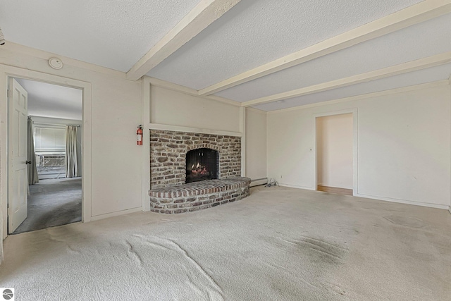 unfurnished living room with a textured ceiling, carpet flooring, beamed ceiling, baseboards, and a fireplace