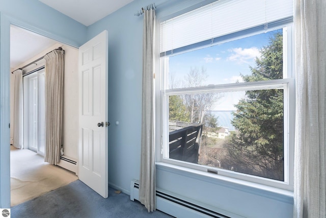 doorway featuring baseboard heating and carpet floors