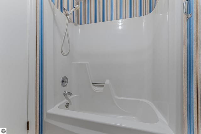 full bathroom with wallpapered walls
