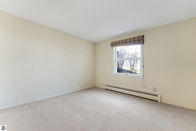 empty room featuring baseboards, light carpet, and a baseboard heating unit