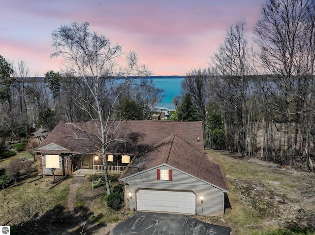 exterior space with driveway, covered porch, and a garage