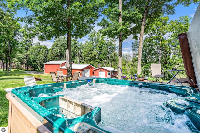 view of swimming pool with an outdoor structure and a lawn