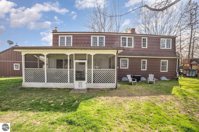1016 Argyle Ct, Alma, MI 48801 - back of house with a lawn, a chimney, and a sunroom