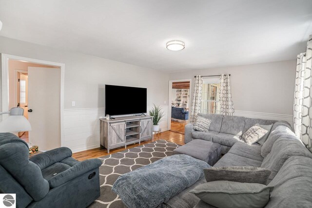 1016 Argyle Ct, Alma, MI 48801 - living room featuring a wainscoted wall and wood finished floors