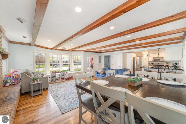 1016 Argyle Ct, Alma, MI 48801 - dining space featuring beam ceiling and light wood-style flooring
