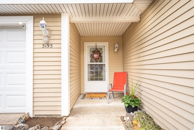 3193 Crimson Ranch Ln, Traverse City, MI 49685 - view of exterior entry with a garage and covered porch