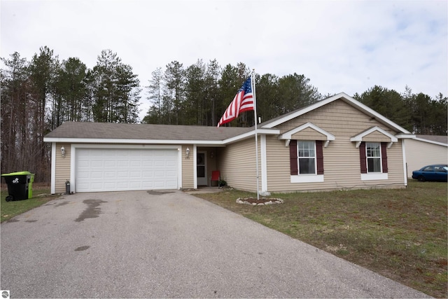 3193 Crimson Ranch Ln, Traverse City, MI 49685 - ranch-style house with driveway and an attached garage